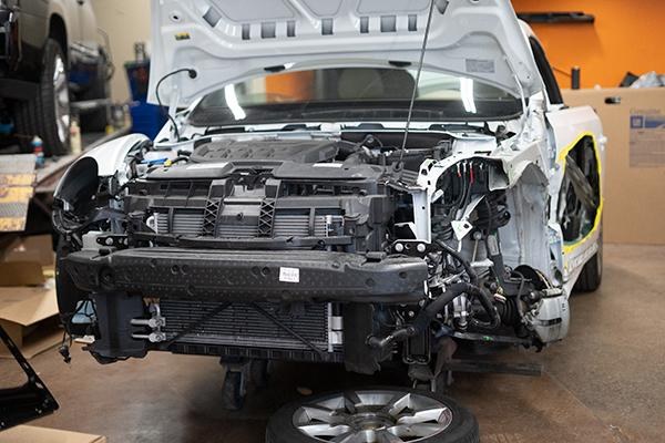 Car with its front end stripped for repair